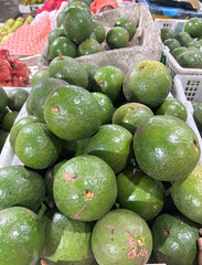 Vibrant Green Avocados in Market Display