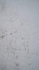 White wall with cracked and peeling surface