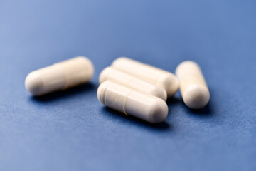 Arginine capsules on bright background. Soft focus. Close up. Copy space.