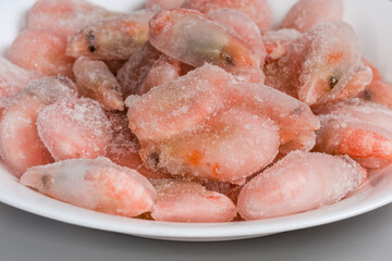 Shrimps in ice glazing on dish, fragment close-up