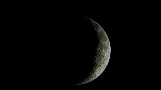 Bright full moon with detailed craters shining in the dark sky, surrounded by stars, capturing a peaceful lunar night scene