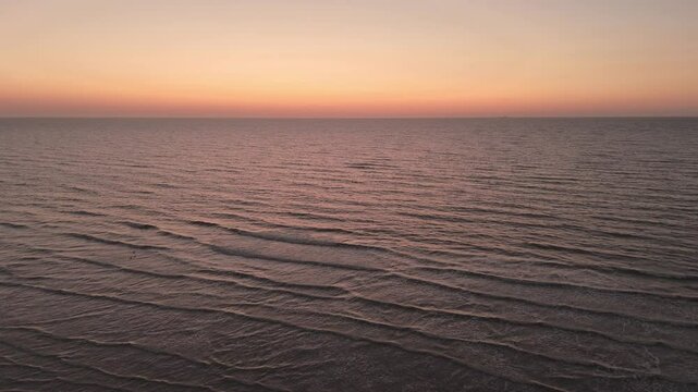 Waves Below: Sunset Aerial View from Above