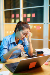Exhausted businesswoman works late into the night, overwhelmed by stress, deadlines, and endless...