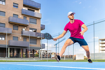 Portrait of a young pickleball player playing an outdoor game. © Ivi - Powerlightss