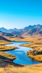 A winding blue lake nestled amidst golden hills and a clear blue sky