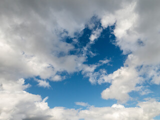 Obraz premium Blue cloudy sky, nature background for design. Clouds have random shape and form.