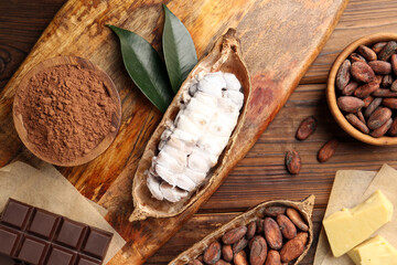 Cocoa pods with beans, chocolate and butter on wooden table, flat lay