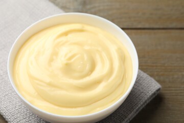 Tasty vanilla pudding on wooden table, closeup