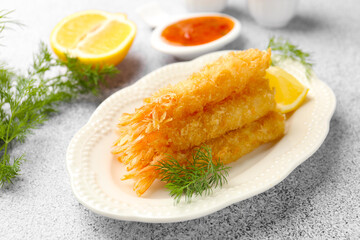 Tasty tempura shrimps, lemon and dill on grey textured table, closeup