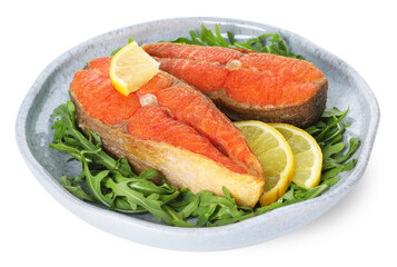 Seafood. Tasty salmon steaks, arugula and lemon isolated on white