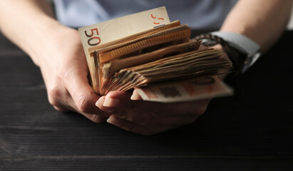 Female Hands Holding Bundle Of Euro Bills In Hands
