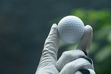 Close-Up of a Golfer Holding a White Golf Ball