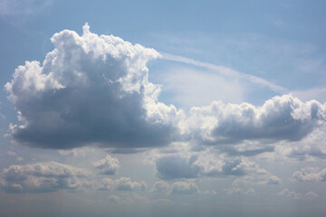 Expansive Blue Summer Sky Dominated By Large, Fluffy White And Grey Cumulus Clouds. Dramatic Cloudscape Formation, Perfect For Weather Or Nature Backgrounds.