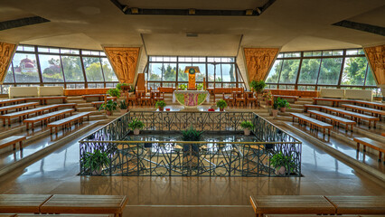 Interior view of the modern Catholic church built over the ancient ruins in Capernaum, Israel. The photo shows the central altar of the Church of St. Peter, suspended above the archaeological remains