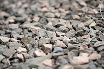 Gray gravel stones for the construction industry. Gravel stones near the railway track. Texture. Background. 