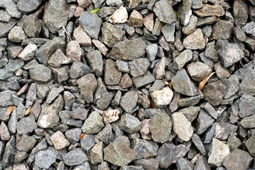 Gray gravel stones for the construction industry. Gravel stones near the railway track. Texture. Background. 
