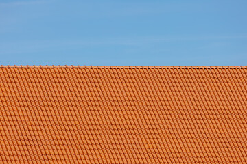 Orange brick rooftop under blue clear sky, Tiles background details, Shingles texture, Abstract geometric pattern, Roof bricks material.