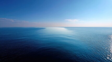 Fototapeta premium The ocean horizon on a sunny day, where the line of the sea and sky meet in a perfect straight line, creating a sense of infinity