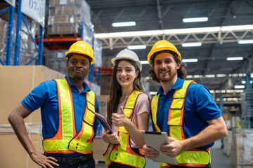 Diverse group of warehouse workers woman and men discussing and reviewing documents with tablet for preparing move goods in package boxes to shelf at factory. Logistics, Distribution Center concept.