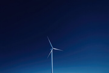 Fototapeta premium minimalistic photo of single wind turbine against clear blue sky