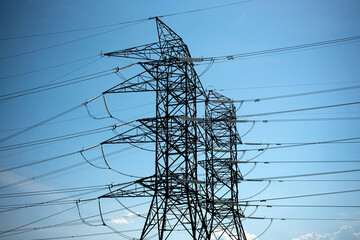 High Voltage Power Lines and Transmission Towers Against Clear Sky