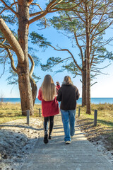 Fototapeta premium Walk along the promenade. A walk by the sea. Walking in nature.