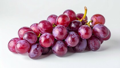 Fototapeta premium Fresh Bunch of Vibrant Red Grapes on a Plain White Surface with Intense Lighting and High Key Exposure