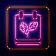 Glowing neon Calendar with autumn leaves icon isolated on black background. Vector