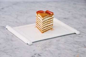 Slice of Classic Medovik Honey Layer Cake layers of honey sponge and creamy filling topped with...