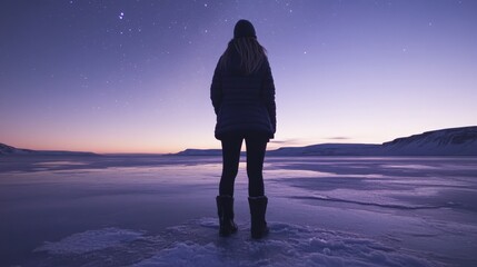 A tourist gazing at the Northern Lights in Iceland, standing on a frozen lake