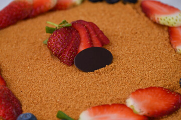 Classic Medovik Honey Layer Cake with Berries decorated with fresh strawberries and blueberries...