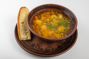 Traditional Ukrainian borscht in a rustic clay bowl, served with sour cream and fresh dill, accompanied by a slice of homemade bread. Classic Slavic cuisine and comfort food
