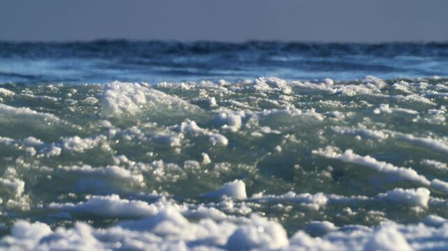 Ice textures of frozen waves and turbulent winter water. Arctic storm footage. 