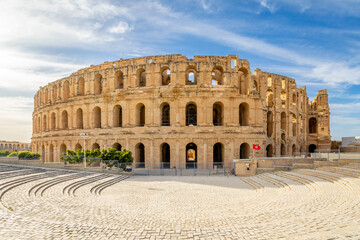Ancient african Roman Colosseum amphitheatre arena panorama with tunisian flag at the entrance, El Jem, Mahdia, Tunis