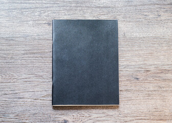 Book mockup blank black A4 leather cover for magazine, booklet, brochure, menu, diary mock-up design template on wooden table background