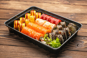 Set of sushi rolls on a wooden table