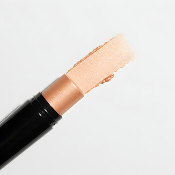 Shimmering Peach Gold Highlighter Stick Makeup Swatches Cosmetic Product Beauty on white background