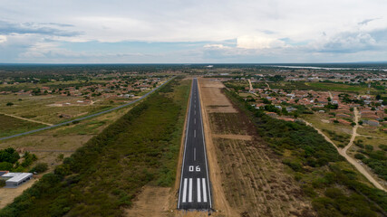 Short of the landing strip 06 in small airport, aerial view, airfield terminal and stopping point for planes and helicopters