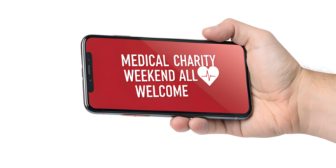 Hand Holding Smartphone Displaying Medical Charity Weekend Announcement