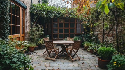Cozy outdoor garden patio with wooden table and chairs surrounded by lush greenery and autumn foliage