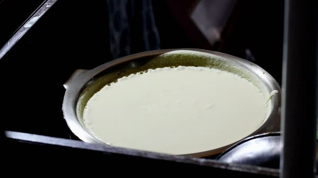 Close up sweet martabak dough in pan. The process of making  Martabak Manis, sweet pancake Indonesian Dessert (terang bulan).
