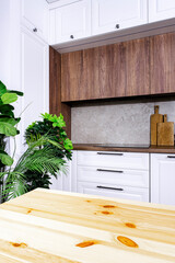 Cozy white and wood kitchen interior with wooden table, modern classic, with induction hob, black...