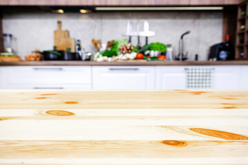 Blurred white and wood kitchen interior with wooden table, modern classic, with induction hob, black sink and furniture fittings, wine bottle holder, knife magnet, kitchen utensils and cookware