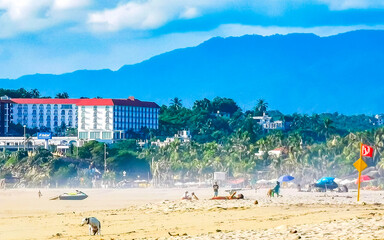 Palms parasols sun loungers beach resort Zicatela Puerto Escondido Mexico.