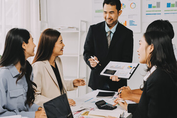 Team of financial advisory services. Asian advisor showing plan of investment to clients in the consultancy office..