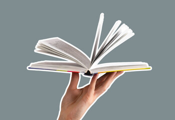 Hand flipping through the pages of an open book, symbolizing education and learning. A mix of