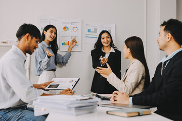 Team of financial advisory services. Asian advisor showing plan of investment to clients in the consultancy office..