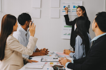 Team of financial advisory services. Asian advisor showing plan of investment to clients in the consultancy office..