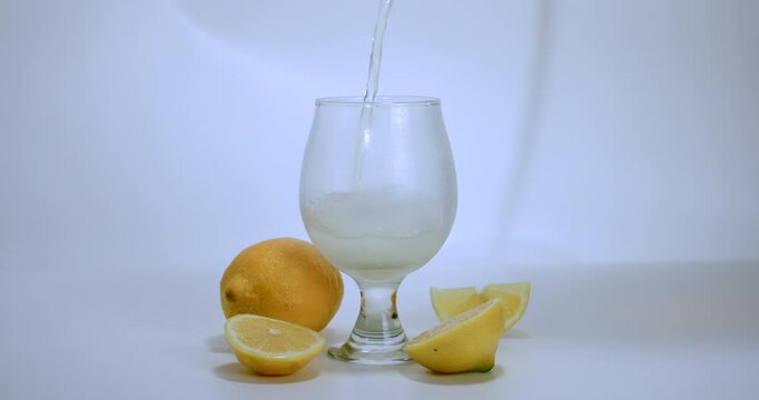 Lemon Soda Pouring into Glass with Rising Foam and Citrus Decor 