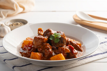 Baked Pork Ribs with Pineapple,Sweet and sour baked Pork Baby Back Ribs or pork cartilage with sliced pineapple and tomato sauce in a plate.